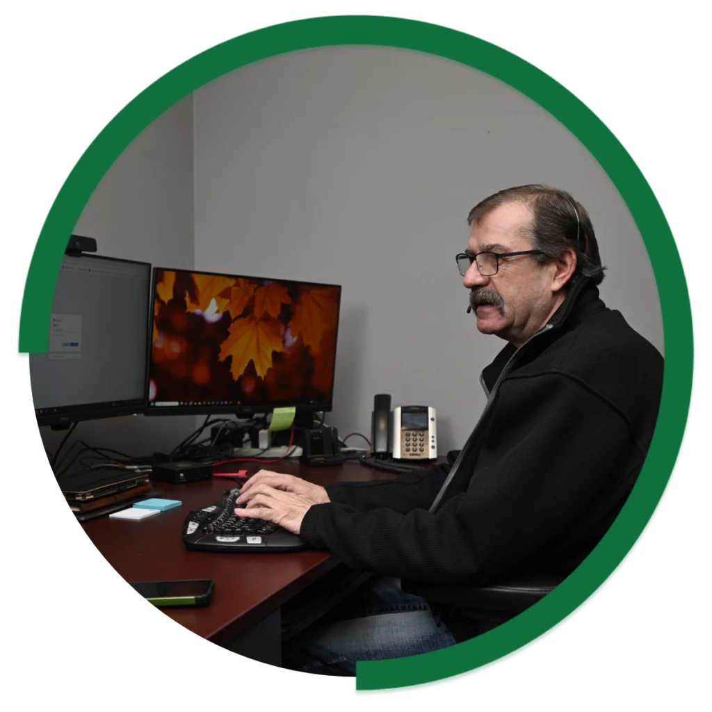 Evolution Group Team Member on computer
