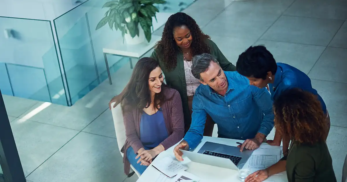 Work team looking at a laptop together
