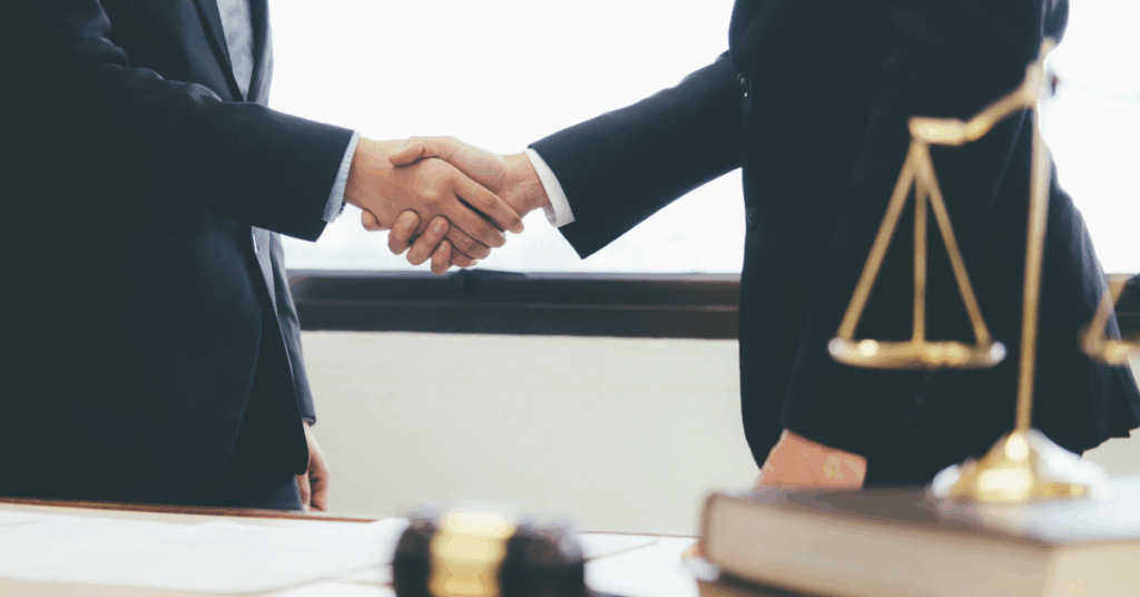 people in suits shaking hands