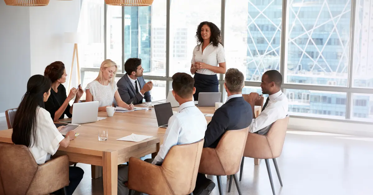 Work team having a meeting listening to manager standing up